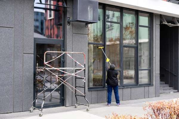 A person cleaning exterior windows