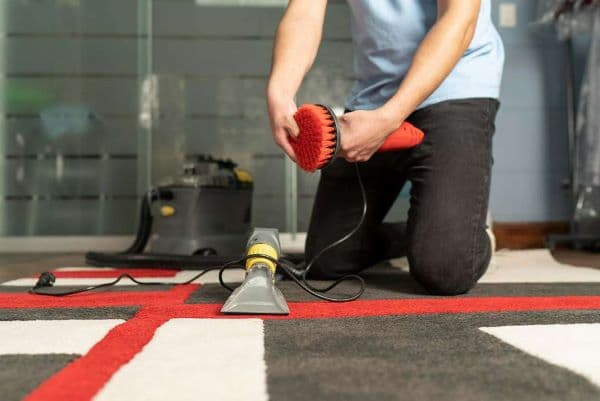 man cleaning a carpet